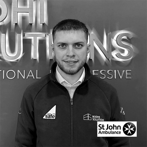 Man wearing Bodhi Solutions jacket with Gas Safe logo stands in front of company sign.