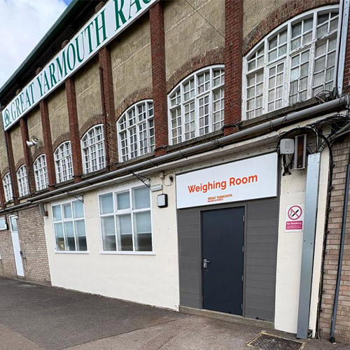 Building exterior with a door labeled 'Weighing Room' at Great Yarmouth Racecourse.